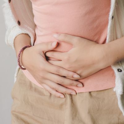 Image of woman holding her tummy - promoting Jana, Gut Health Specialist Sydney